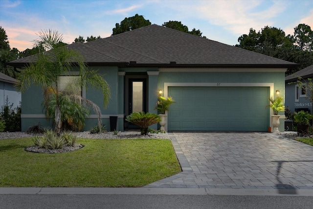57 Green Cir, Palm Coast, FL 32164 - single story home with stucco siding, a shingled roof, a yard, and an attached garage