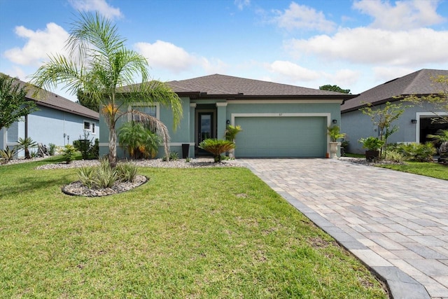 57 Green Cir, Palm Coast, FL 32164 - view of front of home featuring a garage, stucco siding, decorative driveway, and a front lawn