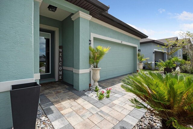 57 Green Cir, Palm Coast, FL 32164 - property entrance with stucco siding, an attached garage, and driveway