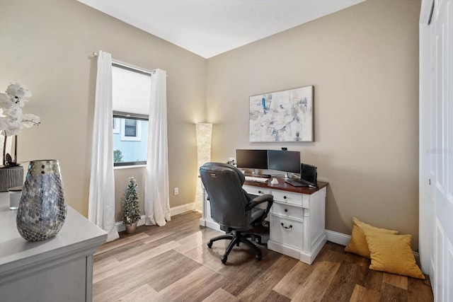 office with light wood-type flooring