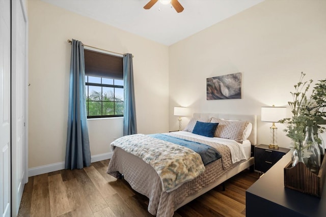 bedroom with dark hardwood / wood-style floors, ceiling fan, and a closet