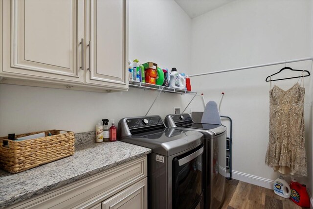 57 Green Cir, Palm Coast, FL 32164 - laundry area with cabinet space, washer and clothes dryer, wood finished floors, and baseboards