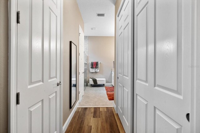 57 Green Cir, Palm Coast, FL 32164 - hallway featuring baseboards and dark wood-style flooring