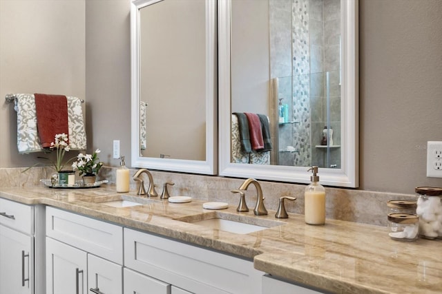 bathroom featuring walk in shower and vanity