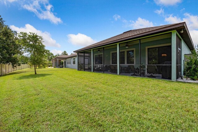 57 Green Cir, Palm Coast, FL 32164 - rear view of property featuring ceiling fan, stucco siding, and a sunroom