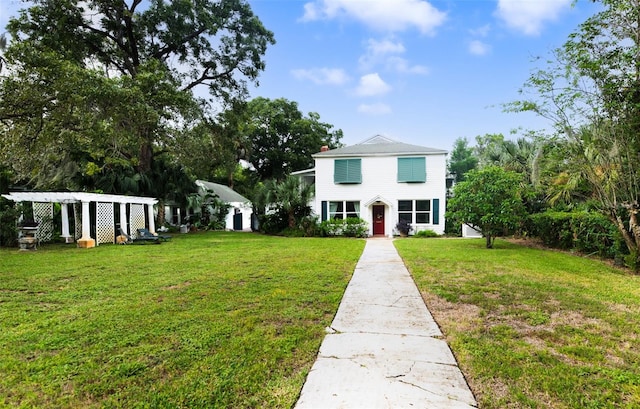 view of front of house with a pergola and a front yard