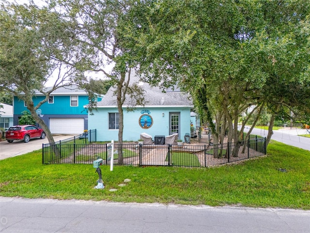 view of front of house with a garage and a front lawn