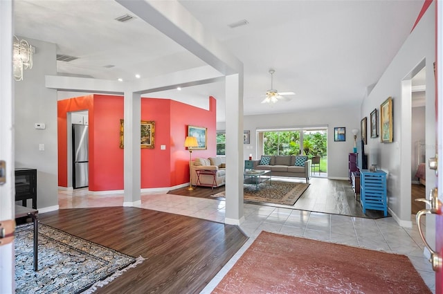 entryway with ceiling fan and light hardwood / wood-style floors