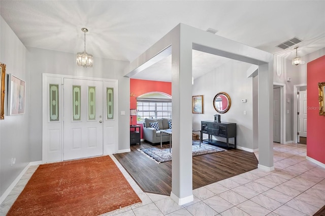 foyer featuring light hardwood / wood-style floors and a notable chandelier