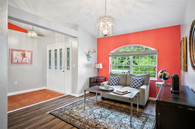 foyer with dark hardwood / wood-style flooring, a chandelier, and lofted ceiling