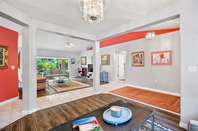 interior space with ceiling fan with notable chandelier, hardwood / wood-style flooring, and lofted ceiling with beams