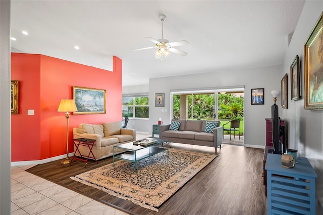 living room featuring light wood-type flooring and ceiling fan