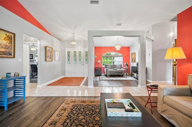 entryway with wood-type flooring and a notable chandelier