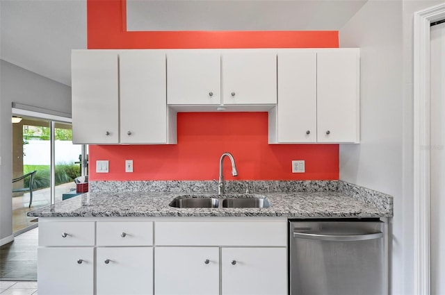 kitchen with white cabinetry, sink, light stone countertops, stainless steel dishwasher, and light hardwood / wood-style floors