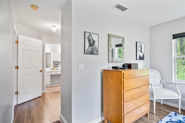 interior space with hardwood / wood-style flooring and a textured ceiling