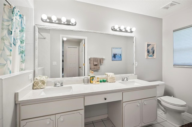 bathroom with tile patterned floors, a shower with curtain, toilet, and vanity