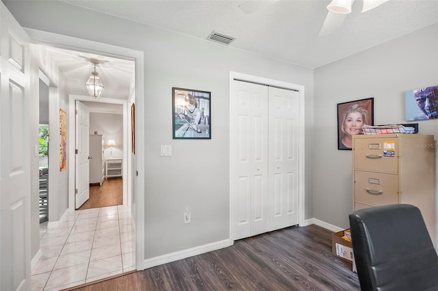 home office featuring a textured ceiling, ceiling fan, and wood-type flooring