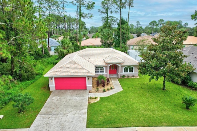 view of front of home with a front yard and a garage