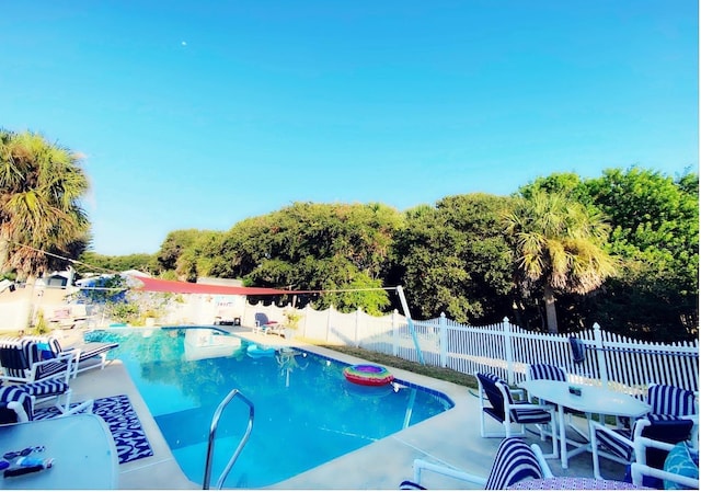 view of swimming pool with a patio