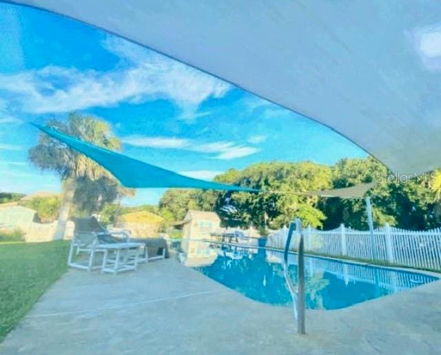 view of swimming pool featuring a patio