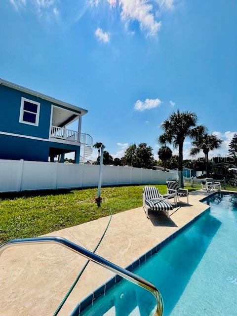 view of swimming pool with a lawn and a patio area