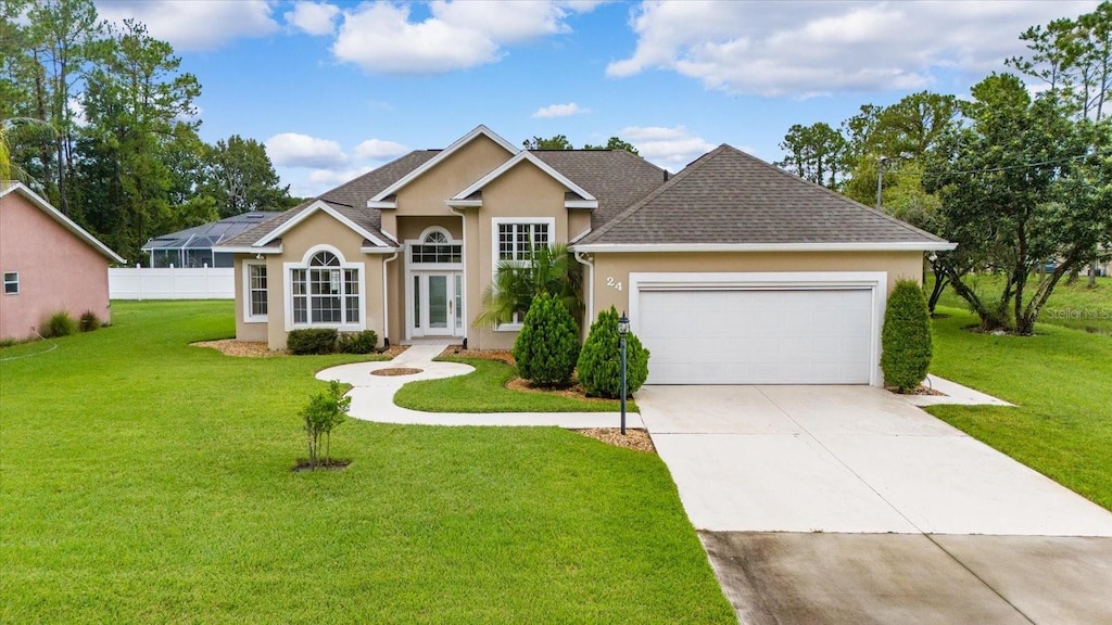 ranch-style house featuring a front yard and a garage