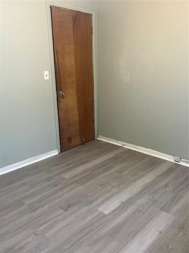 unfurnished room with light wood-type flooring