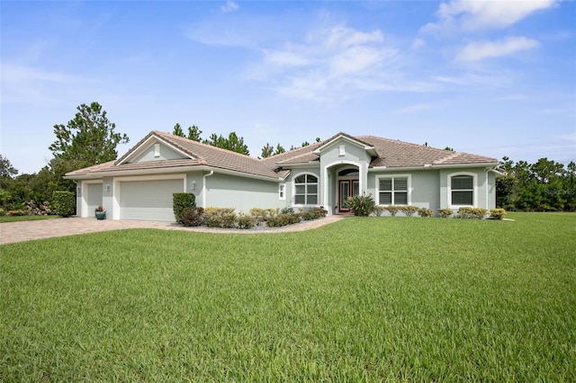 view of front of property featuring a garage and a front yard