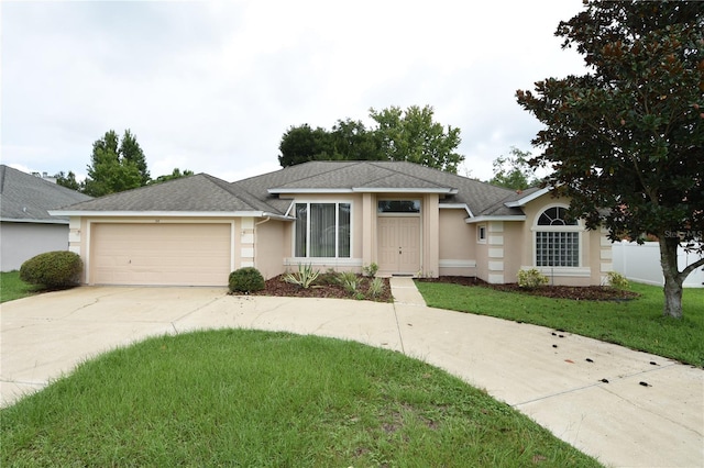 ranch-style house with a garage and a front yard