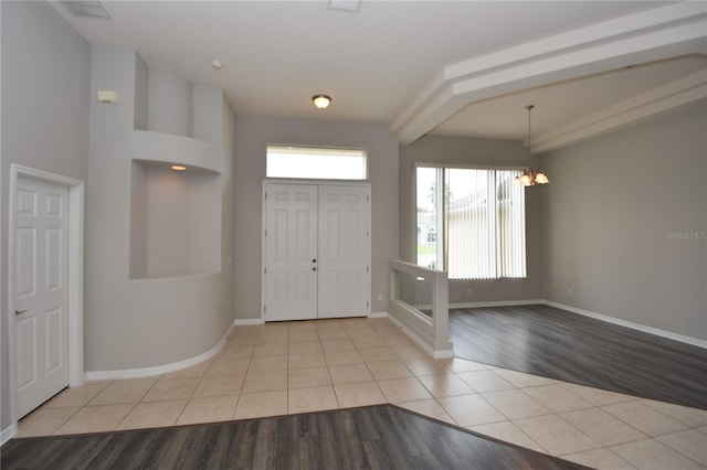 entryway featuring light hardwood / wood-style flooring and a notable chandelier