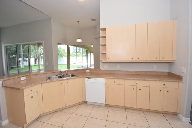 kitchen with dishwasher, decorative light fixtures, sink, kitchen peninsula, and light tile patterned flooring