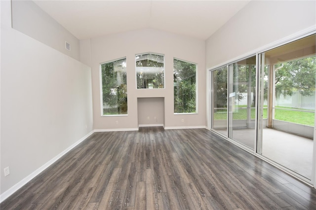 unfurnished room with lofted ceiling and dark hardwood / wood-style flooring