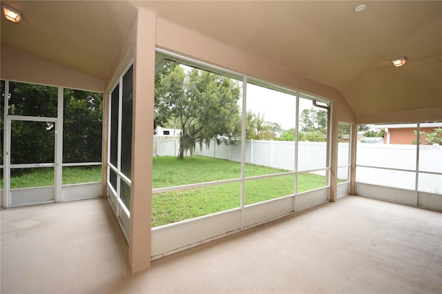 unfurnished sunroom featuring vaulted ceiling