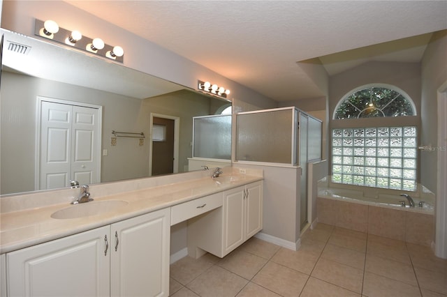 bathroom with a textured ceiling, vanity, separate shower and tub, tile patterned floors, and lofted ceiling