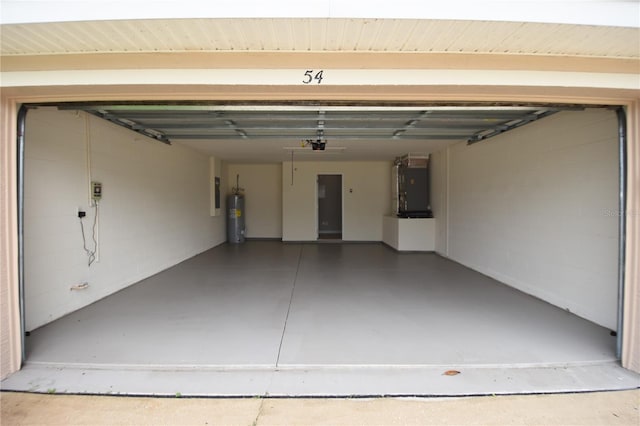 garage featuring water heater, a garage door opener, and heating unit