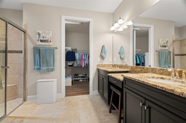 bathroom with vanity, tile patterned floors, and walk in shower