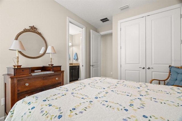 bedroom featuring a closet and ensuite bath