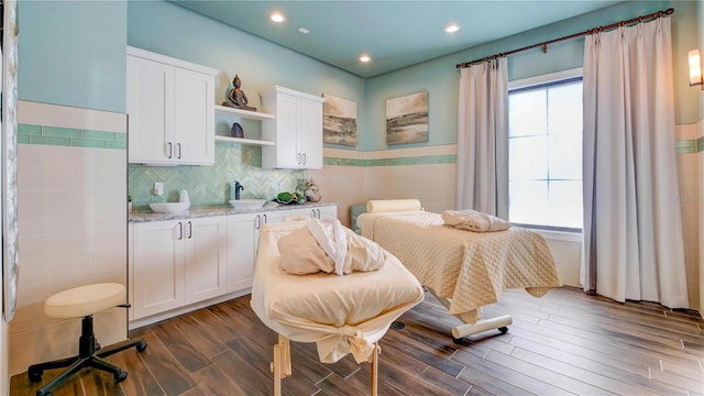 bedroom featuring sink and dark hardwood / wood-style flooring