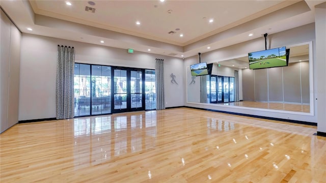 exercise room with light hardwood / wood-style flooring