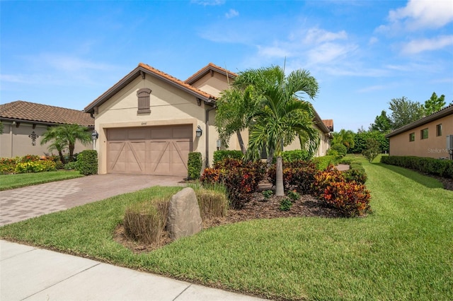 mediterranean / spanish-style home with a front lawn and a garage