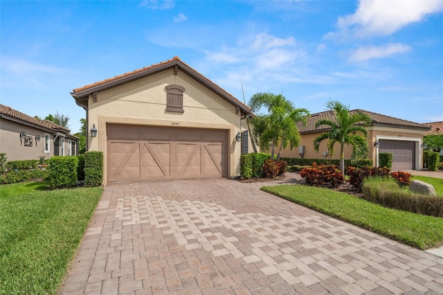 view of front of home featuring a front lawn and a garage