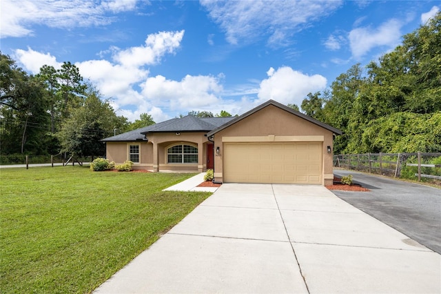 view of front of home featuring a front yard and a garage