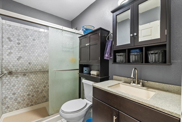 bathroom featuring toilet, vanity, and walk in shower