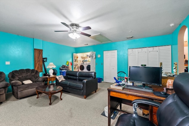 home office with washer and dryer, ceiling fan, carpet, and a textured ceiling