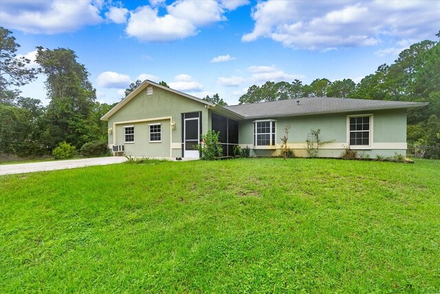 back of property featuring a lawn