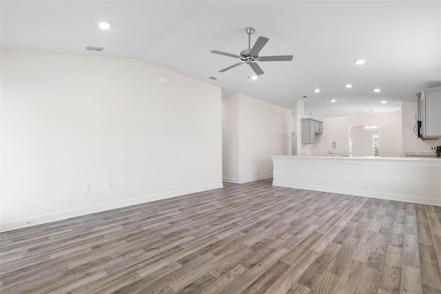 17 Service Berry Pl, Palm Coast, FL 32164 - unfurnished living room with vaulted ceiling, recessed lighting, light wood finished floors, and ceiling fan