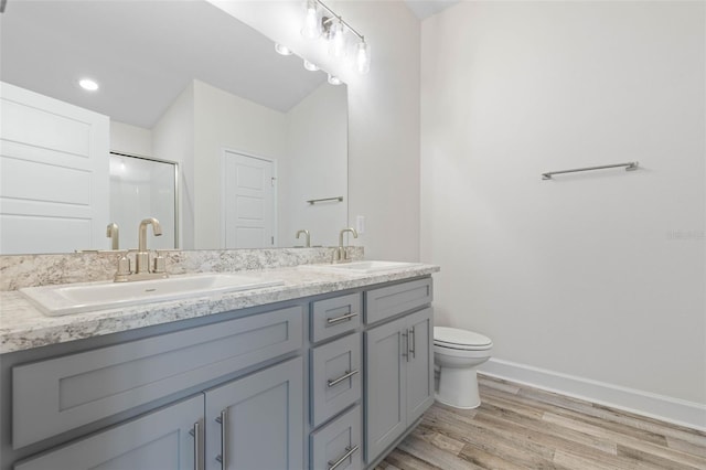 17 Service Berry Pl, Palm Coast, FL 32164 - bathroom featuring double vanity, wood finished floors, an enclosed shower, and recessed lighting