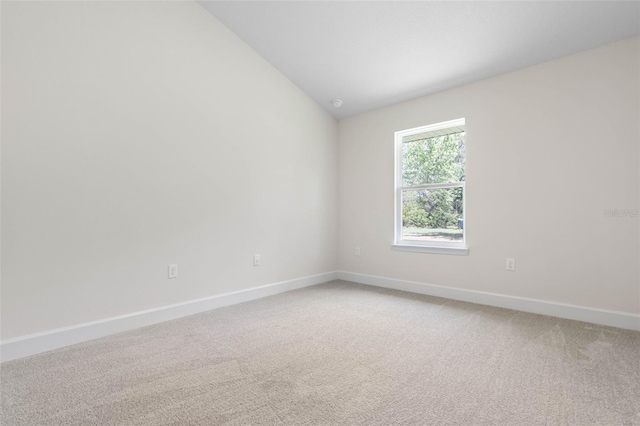 17 Service Berry Pl, Palm Coast, FL 32164 - empty room featuring light colored carpet and vaulted ceiling