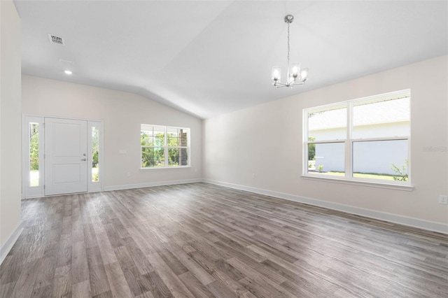 17 Service Berry Pl, Palm Coast, FL 32164 - unfurnished living room with vaulted ceiling, a chandelier, and wood finished floors
