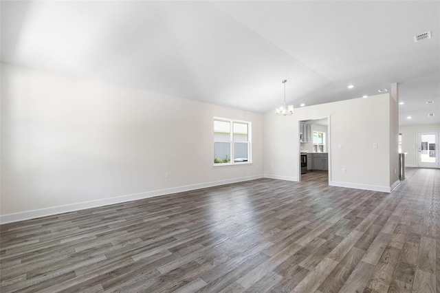 17 Service Berry Pl, Palm Coast, FL 32164 - unfurnished living room with a chandelier, dark wood-type flooring, recessed lighting, and vaulted ceiling